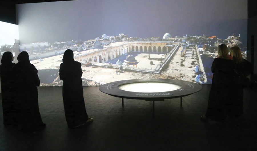 Visitors on a virtual reality tour through the exhibition that highlights heritage sites that have been destroyed or are under threat. (Photo by Saad Al-Dosary)