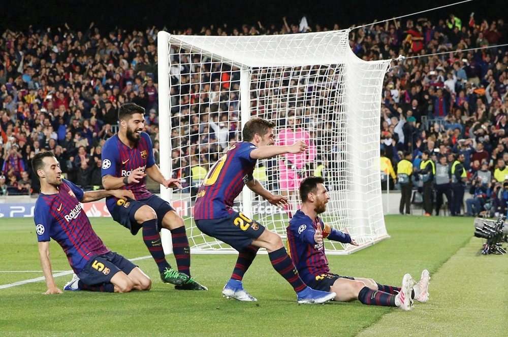 Barcelona's Lionel Messi, right, celebrates after scoring their third goal with Sergi Roberto, Luis Suarez and Sergio Busquets. (Reuters)