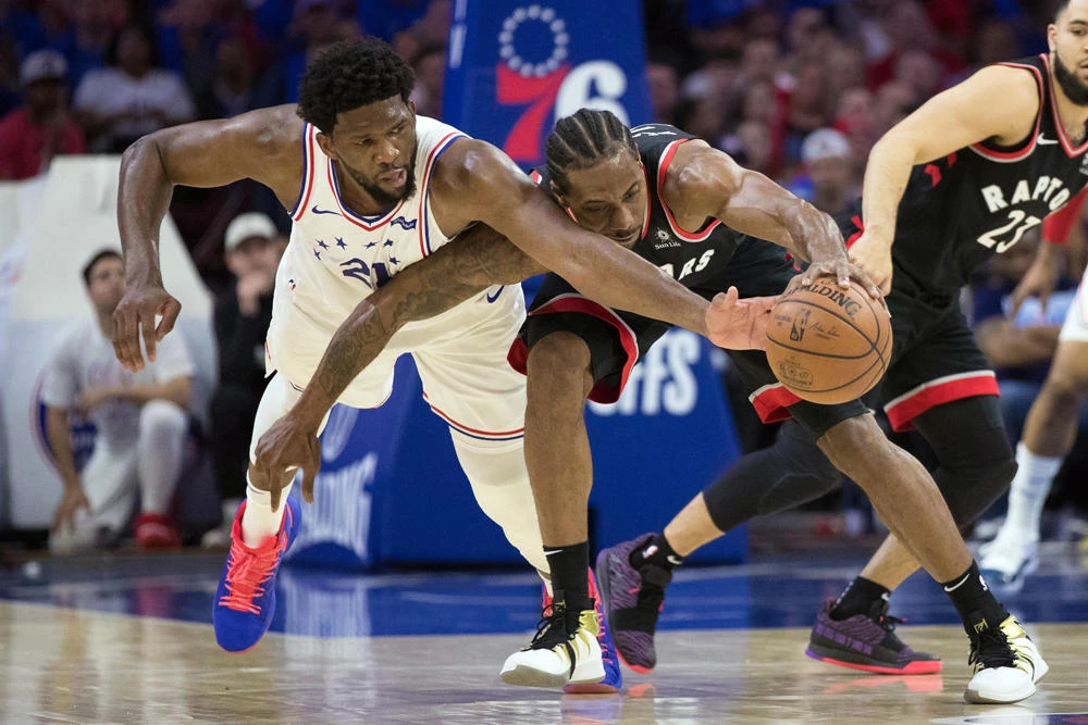 Philadelphia 76ers center Joel Embiid attempts to steal the ball from Toronto Raptors forward Kawhi Leonard during the third quarter in game three of the second round of the 2019 NBA Playoffs at Wells Fargo Center in Philadelphia. ( Bill Streicher-USA TODAY Sports)