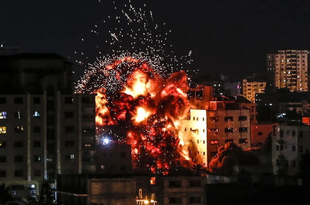 An explosion is pictured among buildings during an Israeli airstike on Gaza City on Saturday. (AFP)