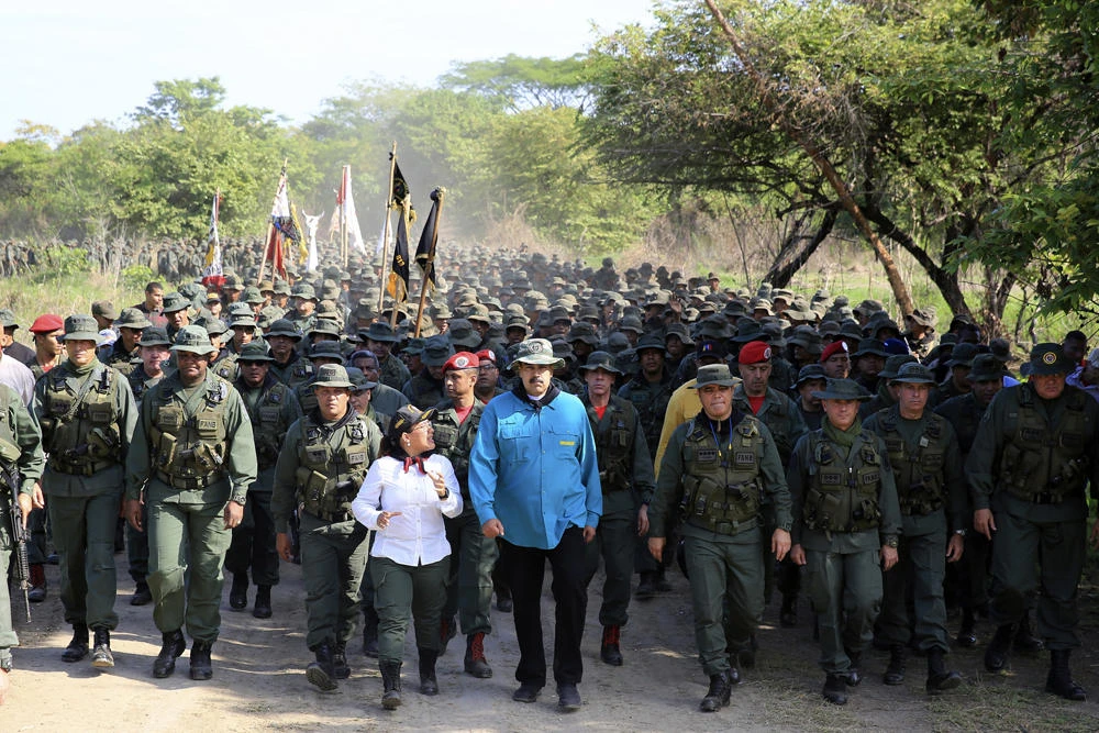 In this handout photo released by Miraflores Press Office, Venezuela's President Nicolas Maduro walks with troops at the G/J Josao Laurencio Silva training center in the state of Cojedes, Venezuela, on May 4, 2019. (Jhonn Zerpa/Miraflores Press Office via AP)