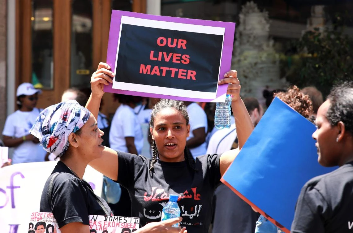 Migrant domestic workers carry placards during a protest in Beirut on Sunday, to call for the abolishment of the sponsorship (kafala) system. (AFP)