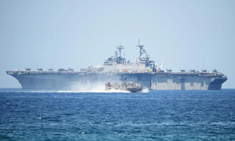 A US Navy hover craft speeds past the USS Wasp, US Navy multipurpose amphibious assault ship, at a joint military exercise in April. (File/AFP)