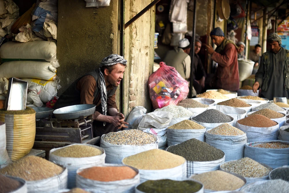 An Afghan vendor watches over his market stall ahead of Ramadan in Kabul on May 5, 2019. (AFP / WAKIL KOHSAR)