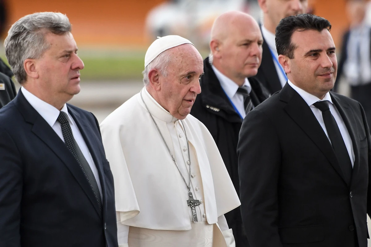 Pope Francis is accompanied by Macedonia’s President Gjorge Ivanov, left, and Prime Minister Zoran Zaev, right, upon his departure from Skopje International Airport at the end of his visit to North Macedonia. (AFP)