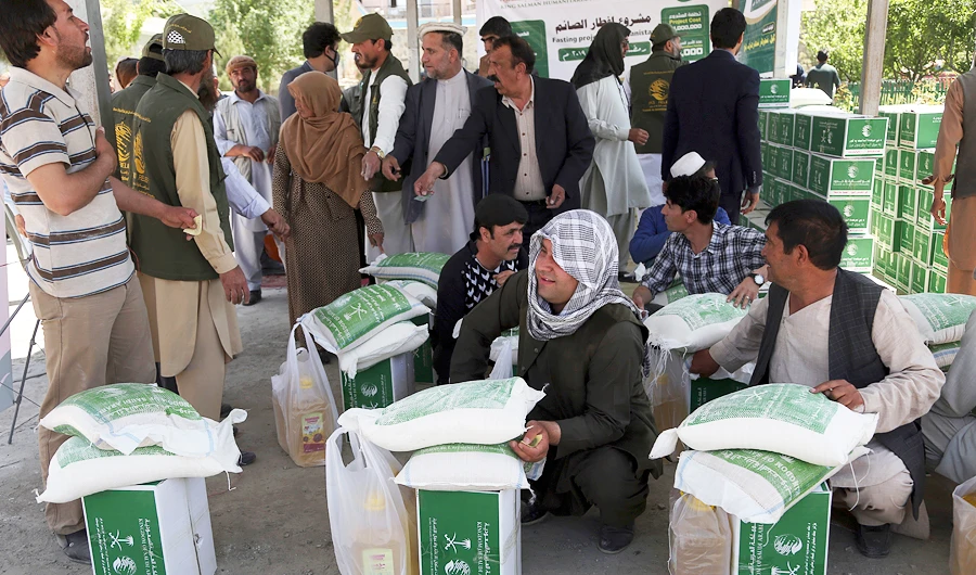 Afghans receive free food donated by King Salman Humanitarian Aid and Relief Center, ahead of the upcoming holy fasting month of Ramadan in Kabul, Afghanistan, Sunday, May 5, 2019. (AP)