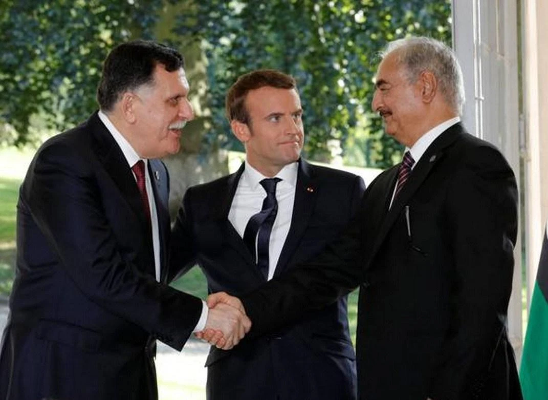 Head of the Libyan Presidency Council, Fayez Al-Sarraj, left, and Field Marshal Khalifa Haftar, head of the Libyan National Army, right, with French president Emmanuel Macron in Paris. (Reuters)