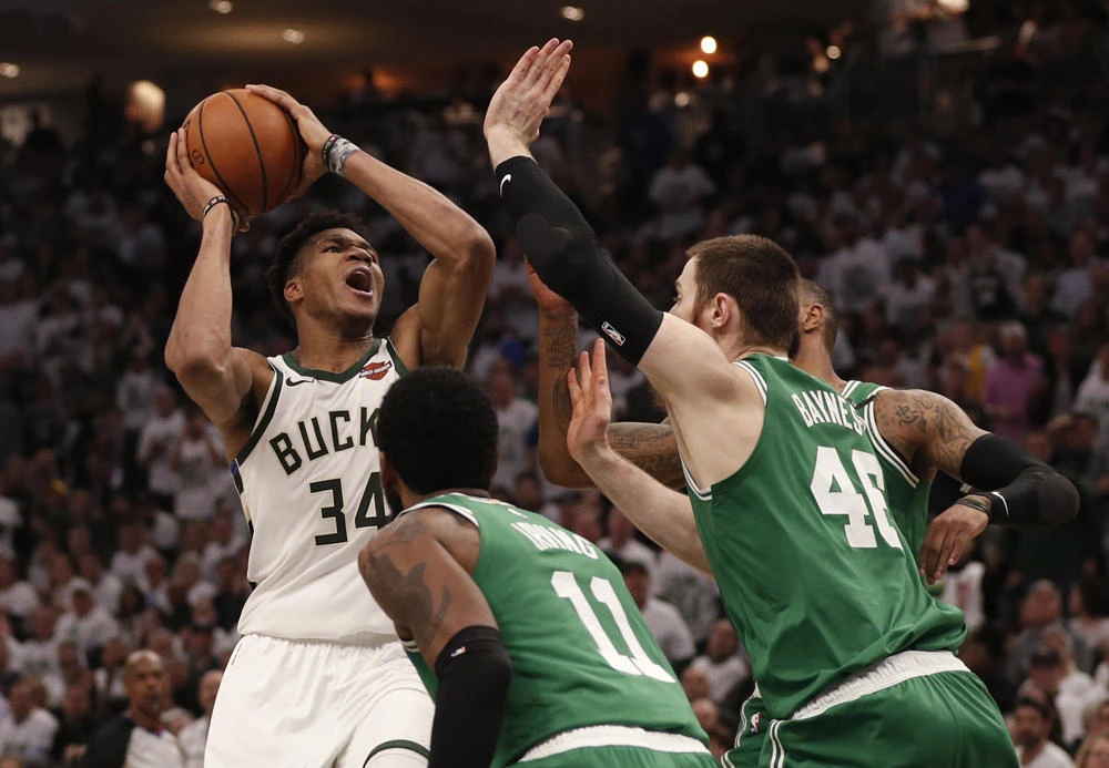 Milwaukee Bucks forward Giannis Antetokounmpo shoots against Boston Celtics point guard Kyrie Irving and center Aron Baynes during the third quarter in game two of the second round of the 2019 NBA Playoffs at Fiserv Forum. (Jeff Hanisch-USA TODAY Sports)
