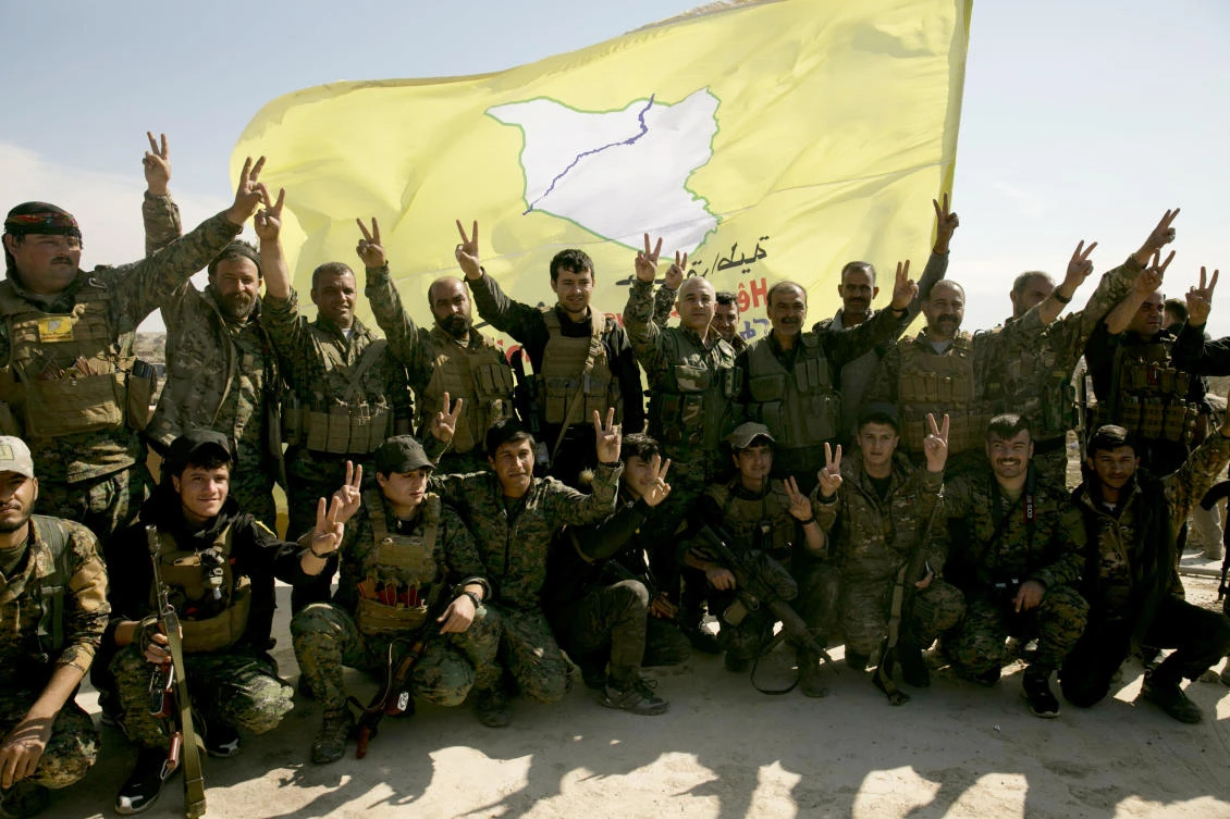 US-backed Syrian Democratic Forces (SDF) fighters pose for a photo in Baghouz, Syria, after the SDF declared the area free of Daesh militants. (File/AP Photo/Maya Alleruzzo)