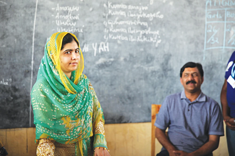 Malala Yousafzai with her father Ziauddin during her recovery from a Taliban gun attack. The young activist caught the world’s attention with her campaign for education rights and her refusal to bow to extremist threats.( Reuters)