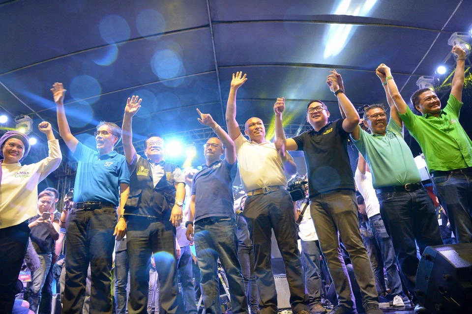 In this photo taken on May 8, 2019, opposition senatorial candidates wave to their supporters during a campaign rally in Manila, ahead of the midterm elections on May 13. (AFP / Ted Aljibe)