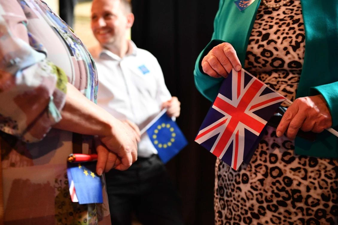 People gather with EU and Union Flags for the launch event for the Liberal Democratic Party candidates for the European Parliament election in London on April 26, 2019. (AFP)