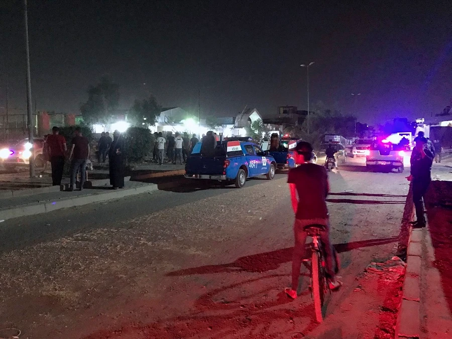 Iraqi security forces and civilians gather at the site of a suicide bomb attack in Baghdad. (AP)