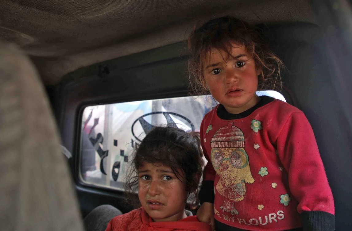 Syrian children react as they leave their home following reported regime shelling on Hama and Idlib provinces, on May 1, 2019. (AFP)