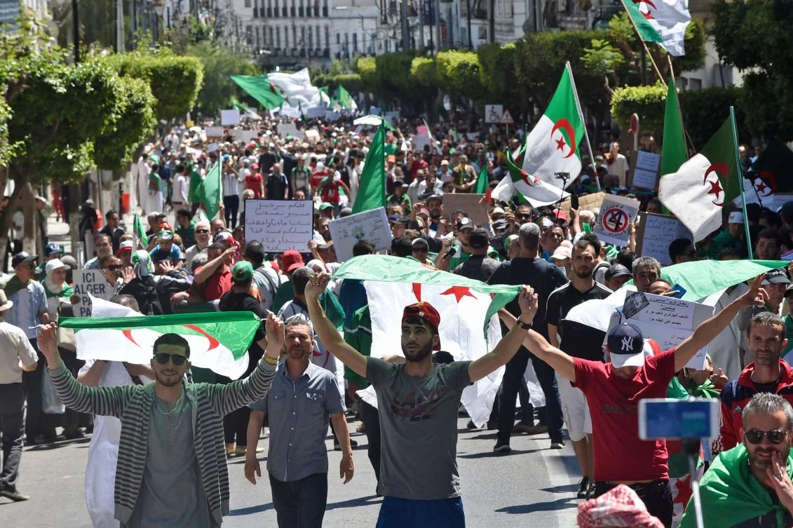 Algerian protesters march with national flags during an anti-government demonstration in the capital Algiers on May 10, 2019. (AFP)