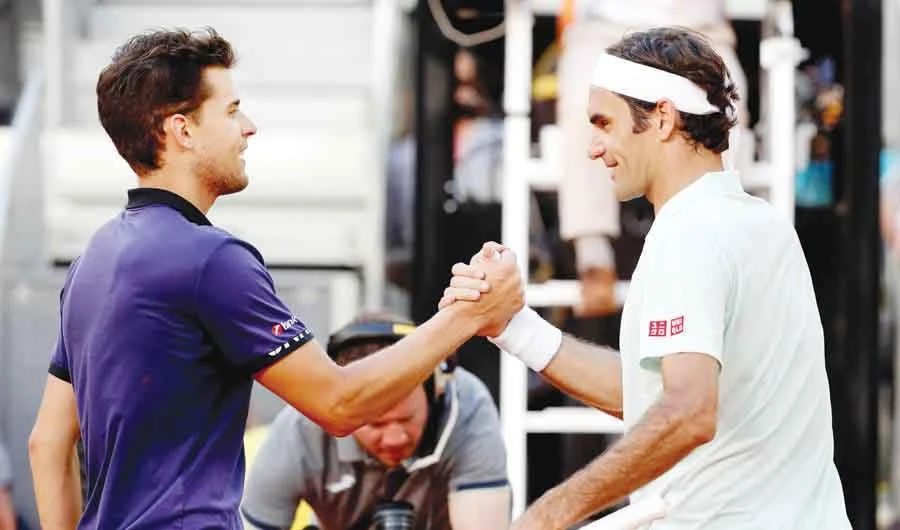 Austria’s Dominic Thiem and Switzerland’s Roger Federer shake hands after their quarter final match in Madrid on Friday. (Reuters)