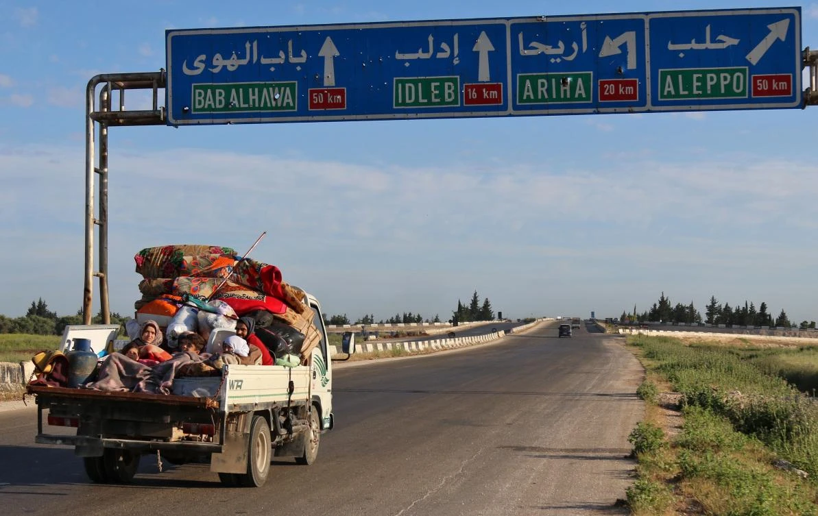 Syrians drive with their belongings along the main Damascus-Aleppo highway near the town of Saraqib in Syria's militant-held Idlib province on May 9, 2019 as they flee possible air strikes by the regime and its allies in the area. (AFP)