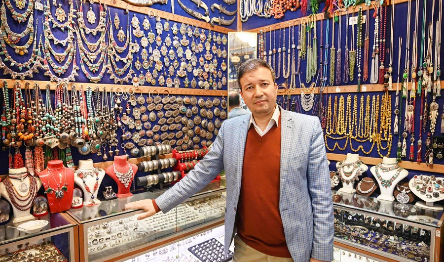 Expert Afghan jeweler Khalil Nuri poses for a picture in his shop at the Grand Bazaar in Istanbul, on April 11, 2019. (AFP)