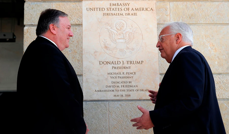In this file photo taken on March 21, 2019, US Secretary of State Mike Pompeo and US ambassador to Israel David Friedman stand next to the dedication plaque at the US embassy in Jerusalem. (AFP / POOL / JIM YOUNG)