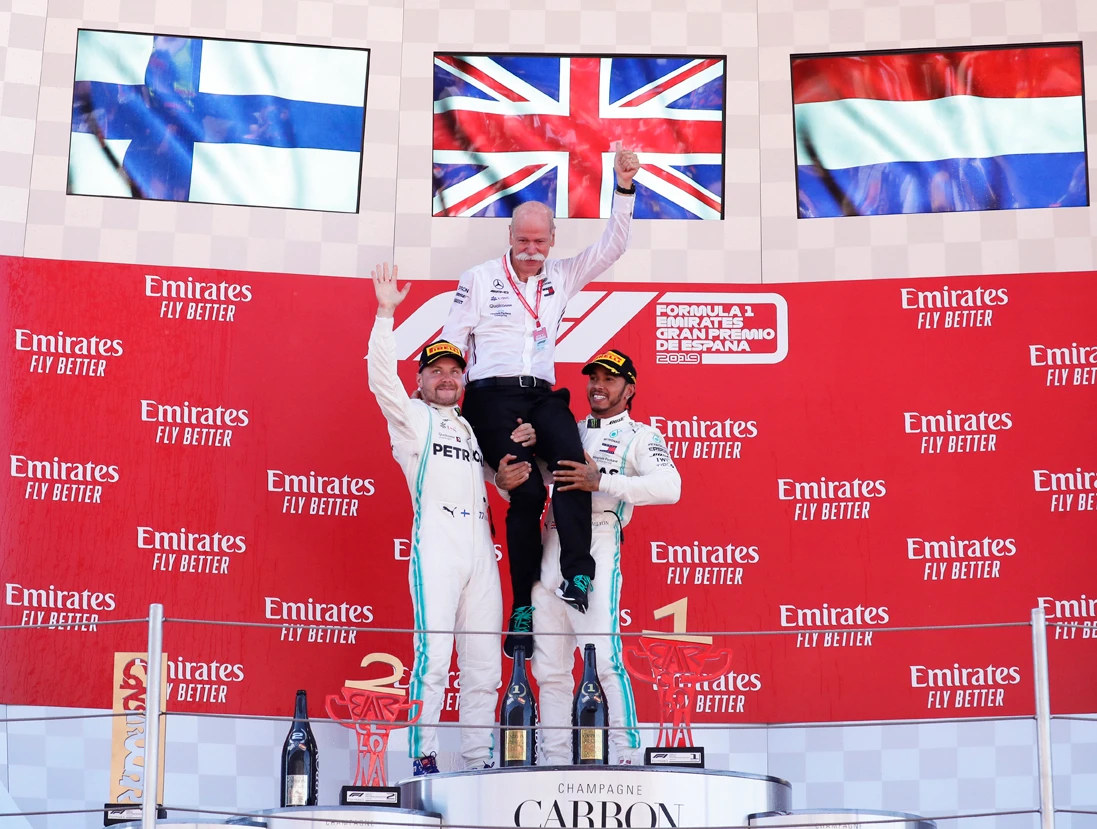 Mercedes driver Lewis Hamilton of Britain, right, and Mercedes driver Valtteri Bottas of Finland celebrate with the chairman of the Board of Management of Daimler AG Dieter Zetsche on the podium during the Spanish Formula One race at the Barcelona Catalunya racetrack in Montmelo, just outside Barcelona, Spain, on May 12, 2019. (AP Photo/Manu Fernandez)