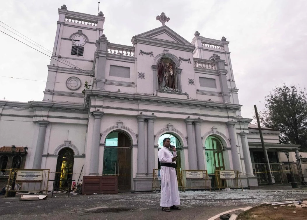 In this file photo taken on April 26, 2019 a priest speaks on a mobile phone outside St. Anthony's Shrine in Colombo, following a series of bomb blasts targeting churches and luxury hotels on Easter Sunday in Sri Lanka. (AFP)