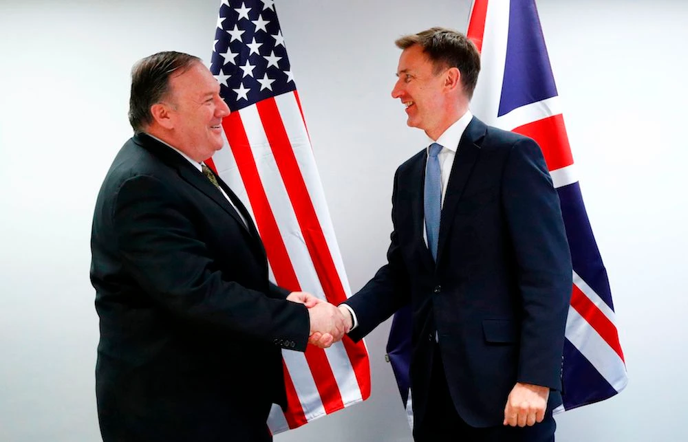 US Secretary of State Mike Pompeo (L) shakes hands with Britain’s Foreign Secretary Jeremy Hunt at the European Council in Brussels on May 13, 2019. (AFP)