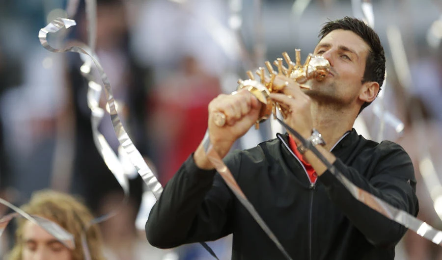 Serbia's Novak Djokovic kisses the trophy as he celebrates winning the final of the Madrid Open tennis tournament in two sets, 6-3, 6-4, against Greece's Stefanos Tsitsipa in Madrid, Spain, on May 12, 2019. (AP Photo/Bernat Armangue)
