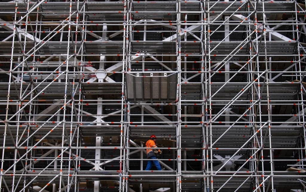 A worker walks on scaffolding at the Axel Springer Campus, still under construction, in Berlin on February 23, 2019. (AFP)