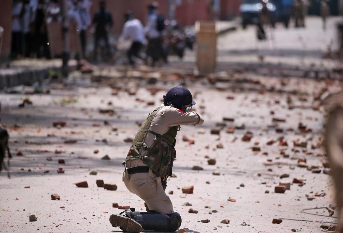 An Indian policeman fires a tear gas shell toward protesters in north Kashmir’s Bandipora district last week in Srinagar on May 14, 2019. (Reuters)