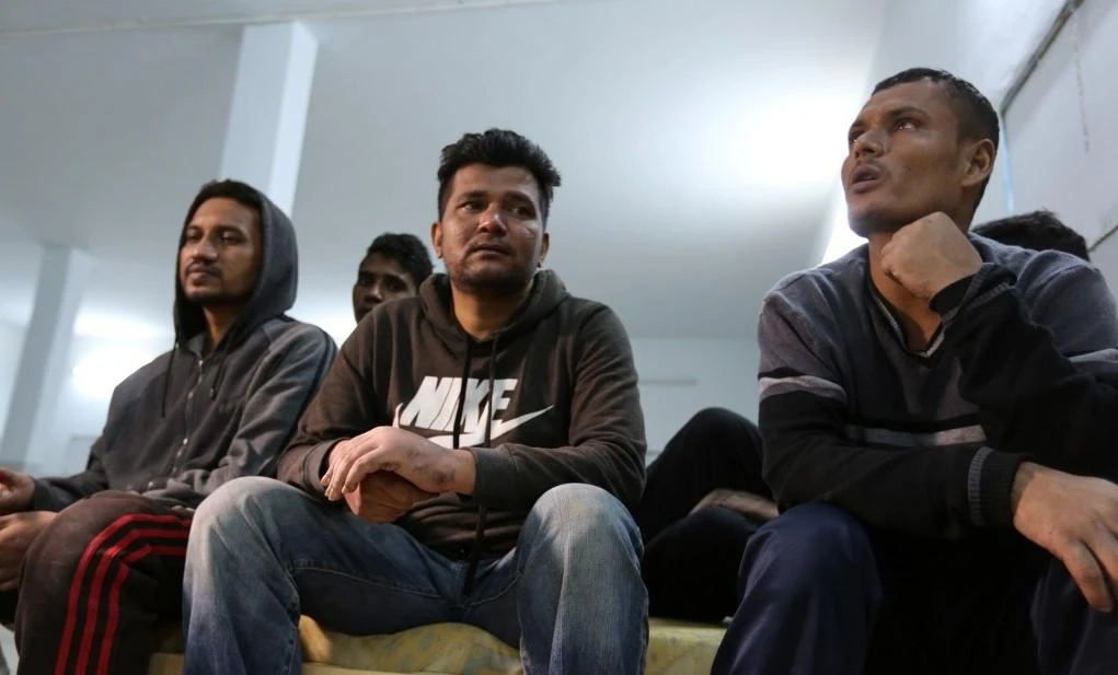 Ahmed Bilal (C), a Bangladeshi and a survivor of a boat carrying migrants that sunk in the Mediterranean during the night of 9 and 10 May, rests with fellow survivors at a shelter in the Tunisian coastal city of Zarzis on May 11, 2019. (AFP)
