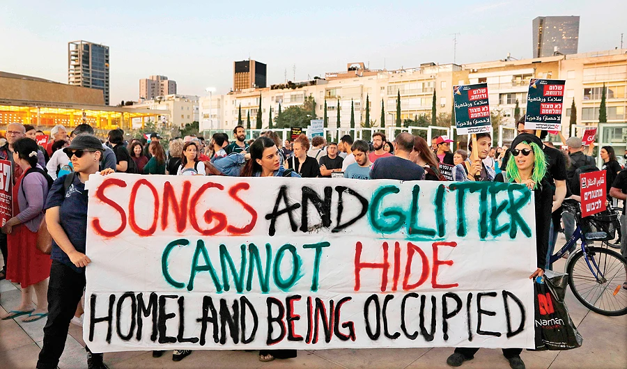 Left-wing Israelis hold a banner during a rally against Eurovision in Tel Aviv on Tuesday. Pro-Palestinian campaigners plan an alternative song contest to draw attention to the country’s occupation. (AFP)