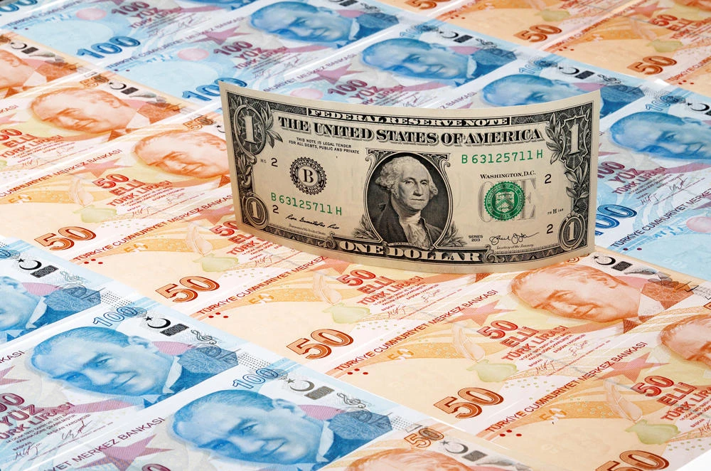 A US dollar banknote is seen on top of 50 and 100 Turkish lira banknotes in this picture illustration in Istanbul, Turkey. Washington on Thursday The United States on Thursday terminated Turkey’s preferential trade treatment that allowed some exports to enter the country duty free. (REUTERS/Illustration/File Photo)