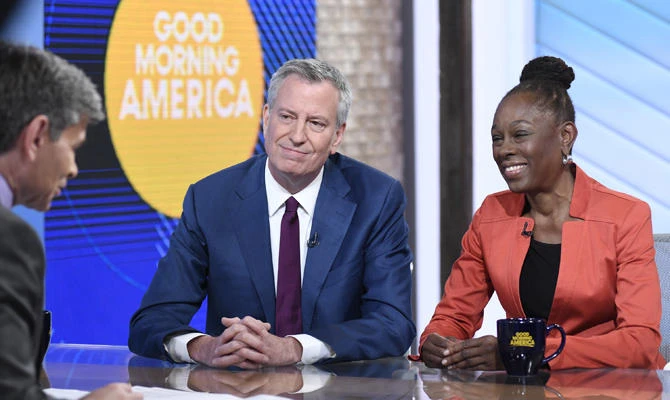 In this photo provided by ABC, George Stephanopoulos, left, interviews New York City Mayor Bill de Blasio and his wife Chirlane McCray on "Good Morning America," on May 16, 2019, in New York. (Paula Lobo/ABC via AP)