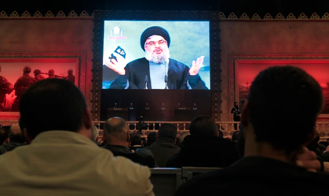 Hezbollah supporters listen to Hezbollah leader Sheik Hassan Nasrallah who is seen speaking through a video in the southern suburb of Beirut, Lebanon, on Thursday Dec. 1, 2011. Nasrallah's influence stretches worldwide, with members believed to be in the US carrying out his agenda. (AP file photo)