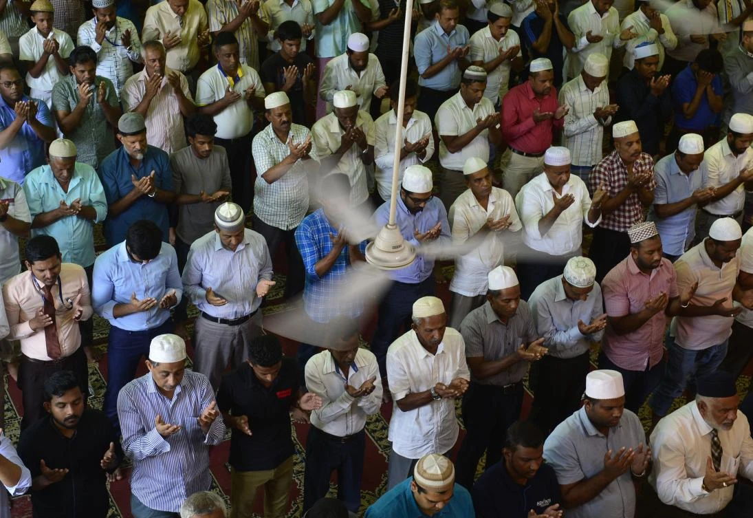 Sri Lankan Muslim men pray during Friday noon prayers at a mosque in Colombo on May 17, 2019. (AFP)