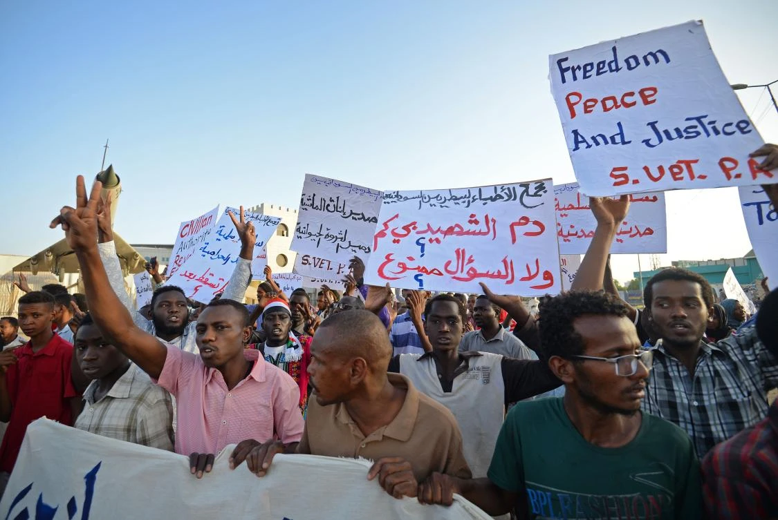 Sudanese protesters chant slogans and wave placards during a demonstration in Khartoum on May 14, 2019. (AFP)