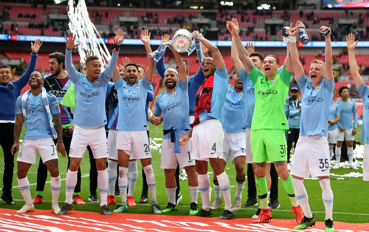 Manchester City's Vincent Kompany celebrates winning the FA Cup final with Ederson, Sergio Aguero and team mates at Wembley. (Reuters)