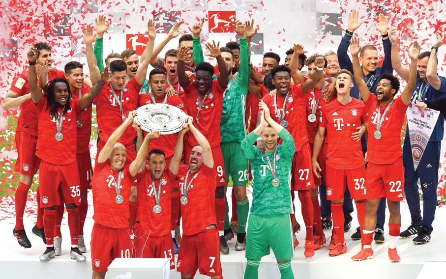 Bayern Munich players celebrate with the trophy after winning the Bundesliga against Eintracht Frankfurt in Munich on Saturday. (Reuters)