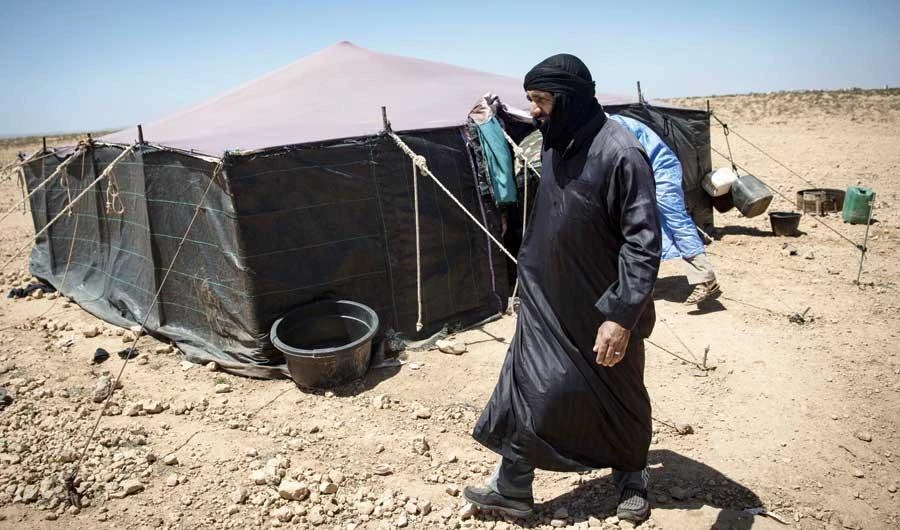 A nomadic herder walks near tents in the Moroccan Tiznit province in the region of Souss-Massa, which has drawn in nomadic herders for decades. (AFP)