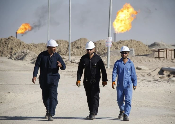 Iraqi workers walk in West Qurna oilfield in Iraq’s southern province of Basra. (File/Reuters)