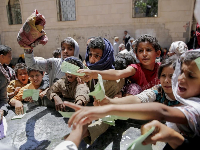 Yemeni children present documents in order to receive food rations provided by a local charity, in Sanaa. The World Food Programme is (AP)
