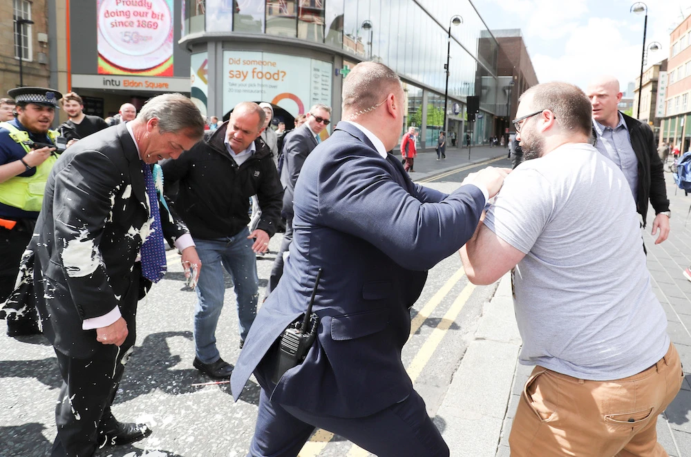 Brexit Party leader Nigel gestures after being hit with a milkshake while arriving for a Brexit Party campaign event in Newcastle, Britain, May 20, 2019. (Reuters)