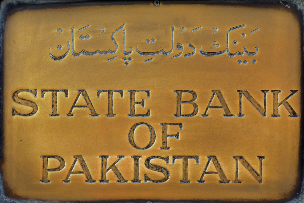 A brass plaque of the State Bank of Pakistan is seen outside of its wall in Karachi, Pakistan. (File/Reuters)