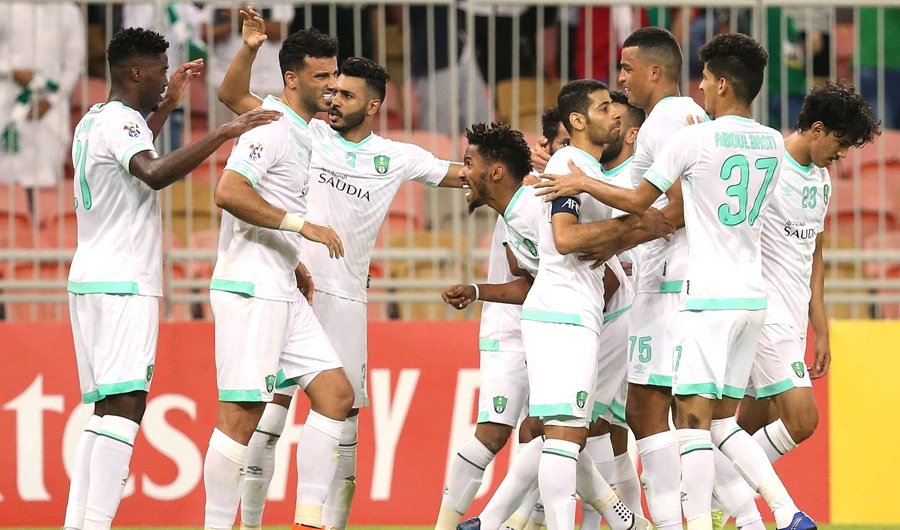 Al-Ahli’s players celebrate after winning against Uzbekistan’s Pakhtakor on Monday night. (AFP)