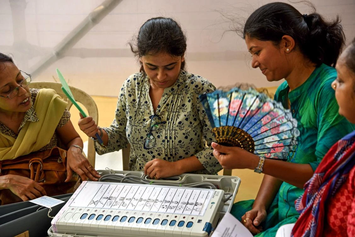 Indian polling officials check an Electronic Voting Machine at a distribution center in Kolkata on May 18, 2019, on the eve of the seventh phase of India’s general election. (AFP)