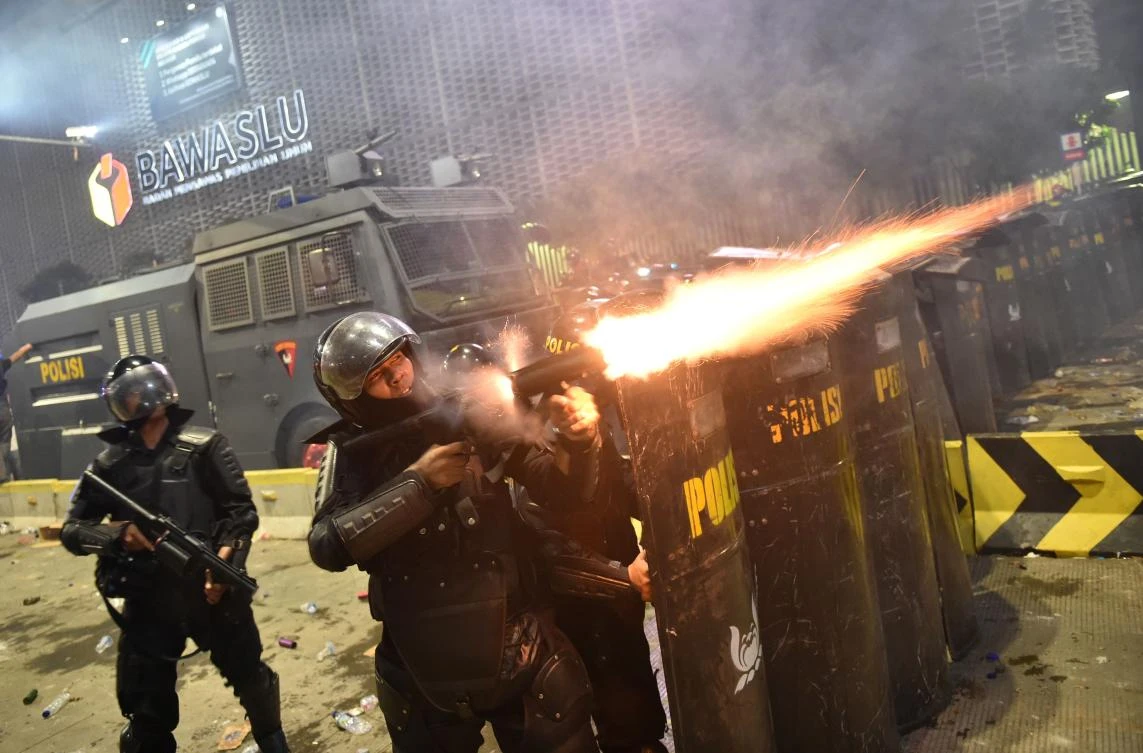 Indonesian anti-riot police shoot tear gas to disperse protesters during a demonstration against Indonesia’s President Joko Widodo’s victory in the recent election in Jakarta on May 22, 2019. (AFP)