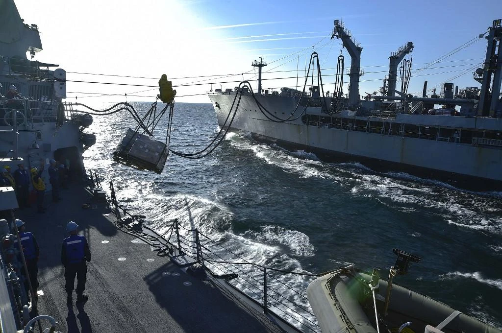 Above, the replenishment oiler USNS Walter S. Diehl transfers cargo to the deck of the Arleigh Burke-class guided-missile destroyer USS Gridley during a replenishment-at-sea in this December 15, 2014 photo. (US Navy/AFP)