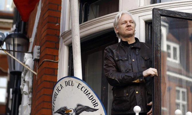In thisMay 19, 2017 file photo, WikiLeaks founder Julian Assange looks out from the balcony while claiming political asylum at the Ecuadorian embassy in London. (AP Photo/Frank Augstein, File)