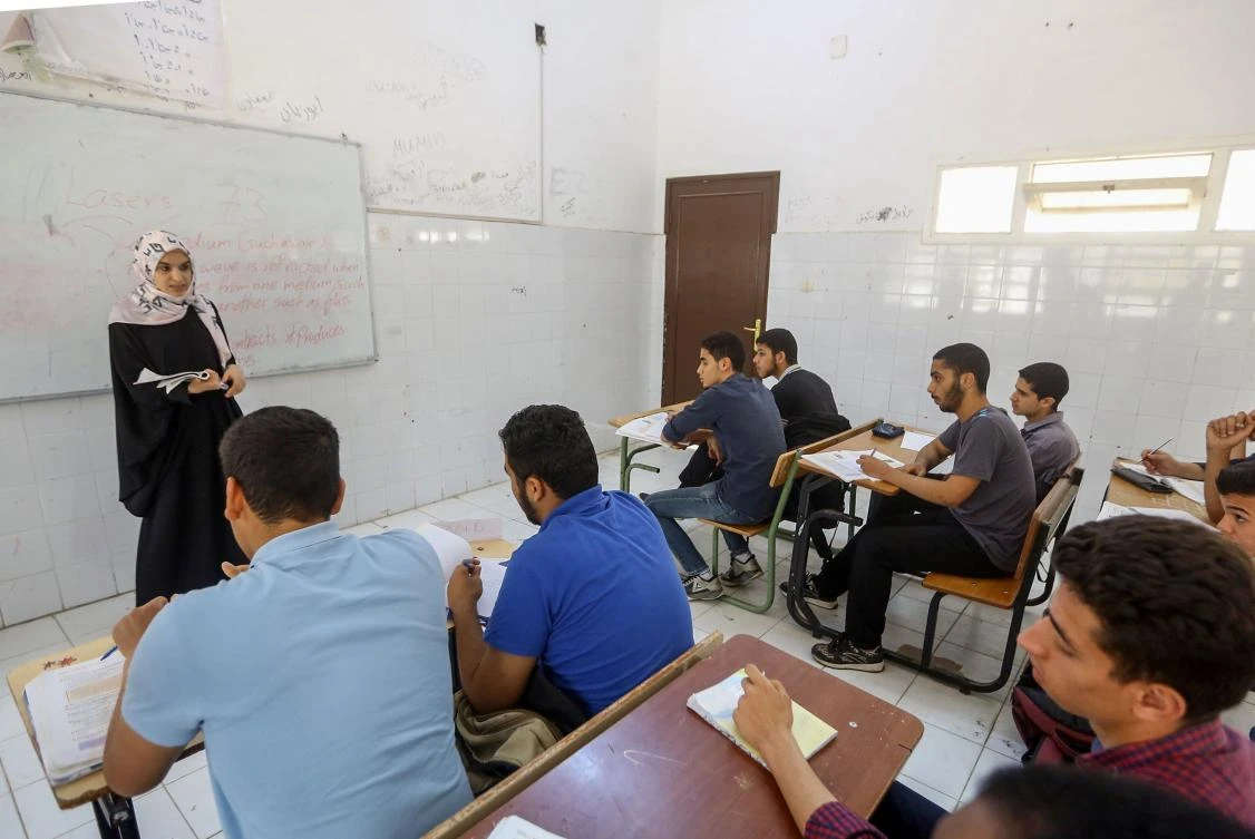 Displaced Libyan students from areas of clashes between Haftar's self-styled Libyan National Army and forces loyal to the unity government, attend a lesson at a school on the southern outskirts of the capital Tripoli on May 20, 2019. (AFP)