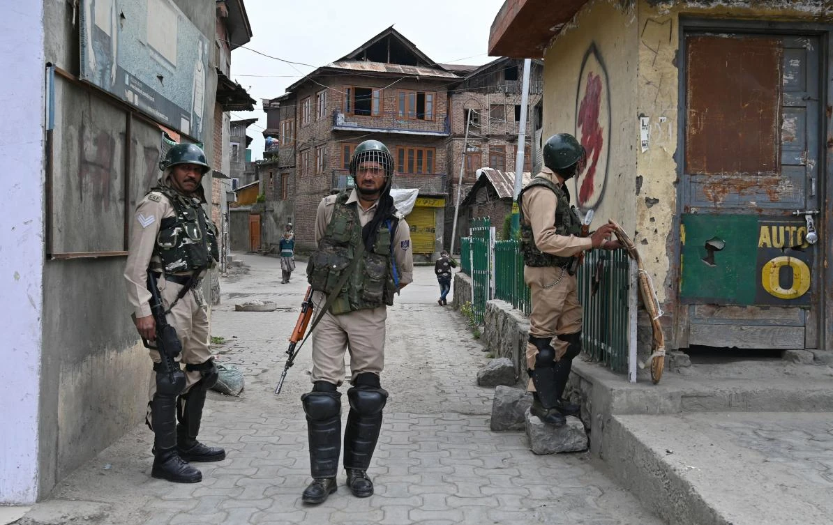 Above, Indian paramilitary troopers stands infront of closed shops during a one day strike in downtown Srinagar on May 17,2019. (AFP)